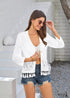 Cárdigan bohemio blanco de punto de crochet calado con borlas estilo 2024